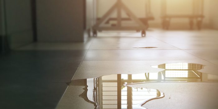 A water leak on the floor of a residential building, identified as clean water, the first type of water classification.